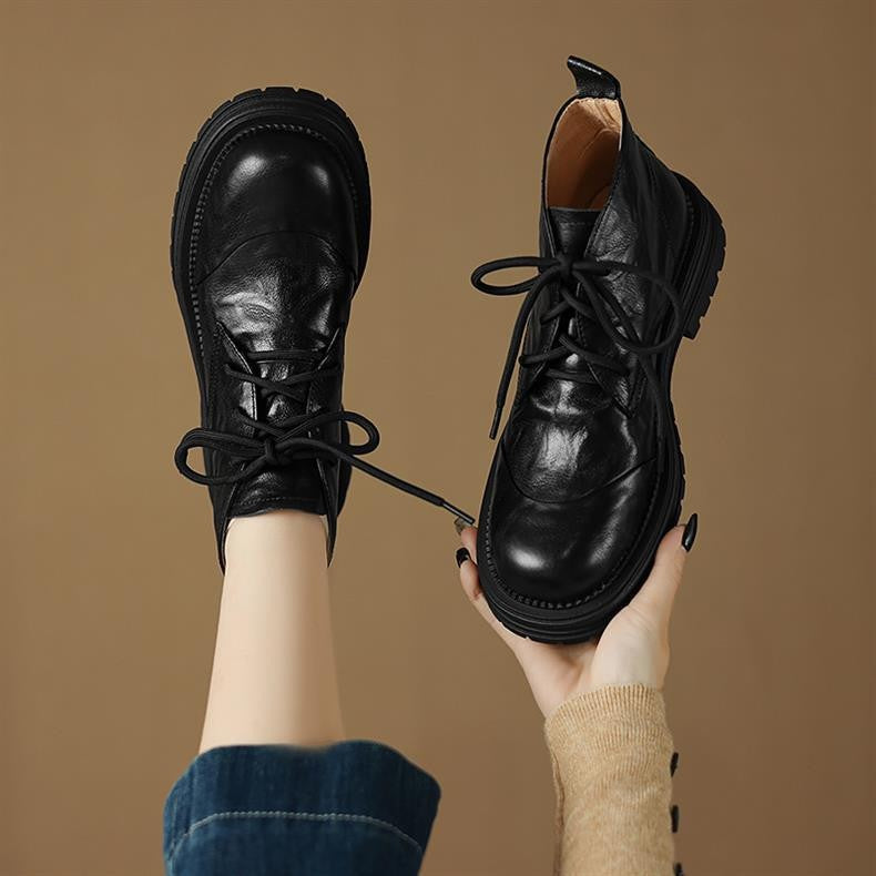 Women’s black lace-up ankle boots with round toe, chunky lug sole, pull tab