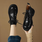 Women’s black lace-up ankle boots with round toe, chunky lug sole, pull tab
