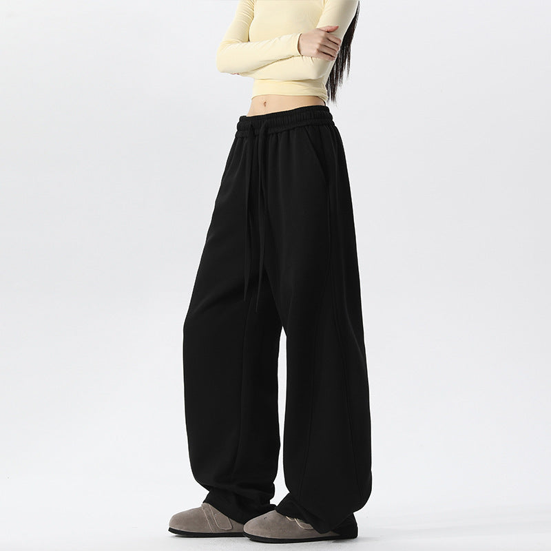 Women's black wide-leg sweatpants with elastic waistband and drawstring ties