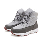 Pair of women's light gray lace-up snow boots with quilted detailing and dark trim