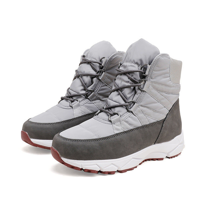 Pair of women's light gray lace-up snow boots with quilted detailing and dark trim