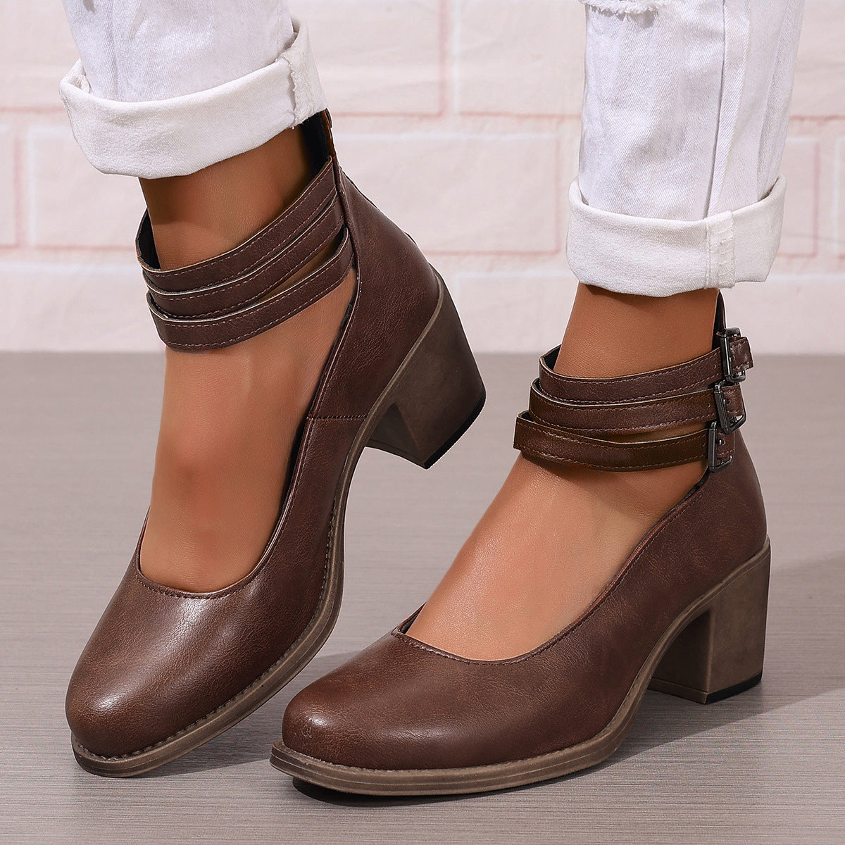 Brown closed-toe block heel pumps with ankle strap and side buckle