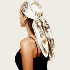 Off-white satin head scarf with ornate print, large square wrap tied at the side