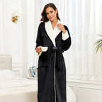 Women’s black plush fleece long robe with white shawl collar, belt tie, open front.