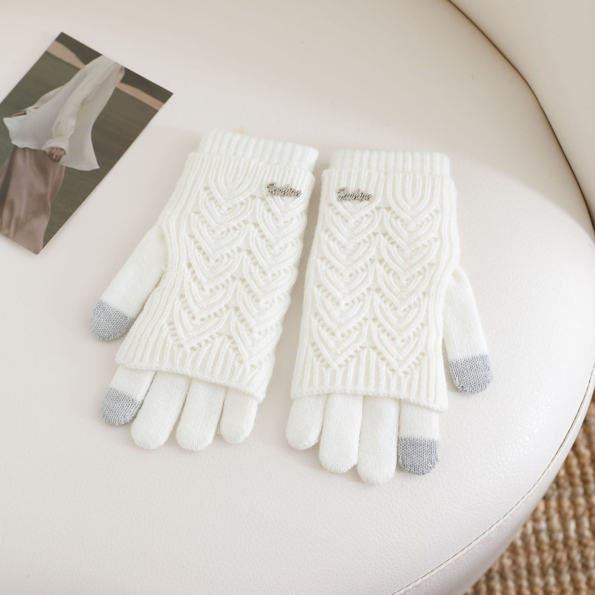 Women’s white fingerless knit gloves with ribbed cuffs and textured wave pattern
