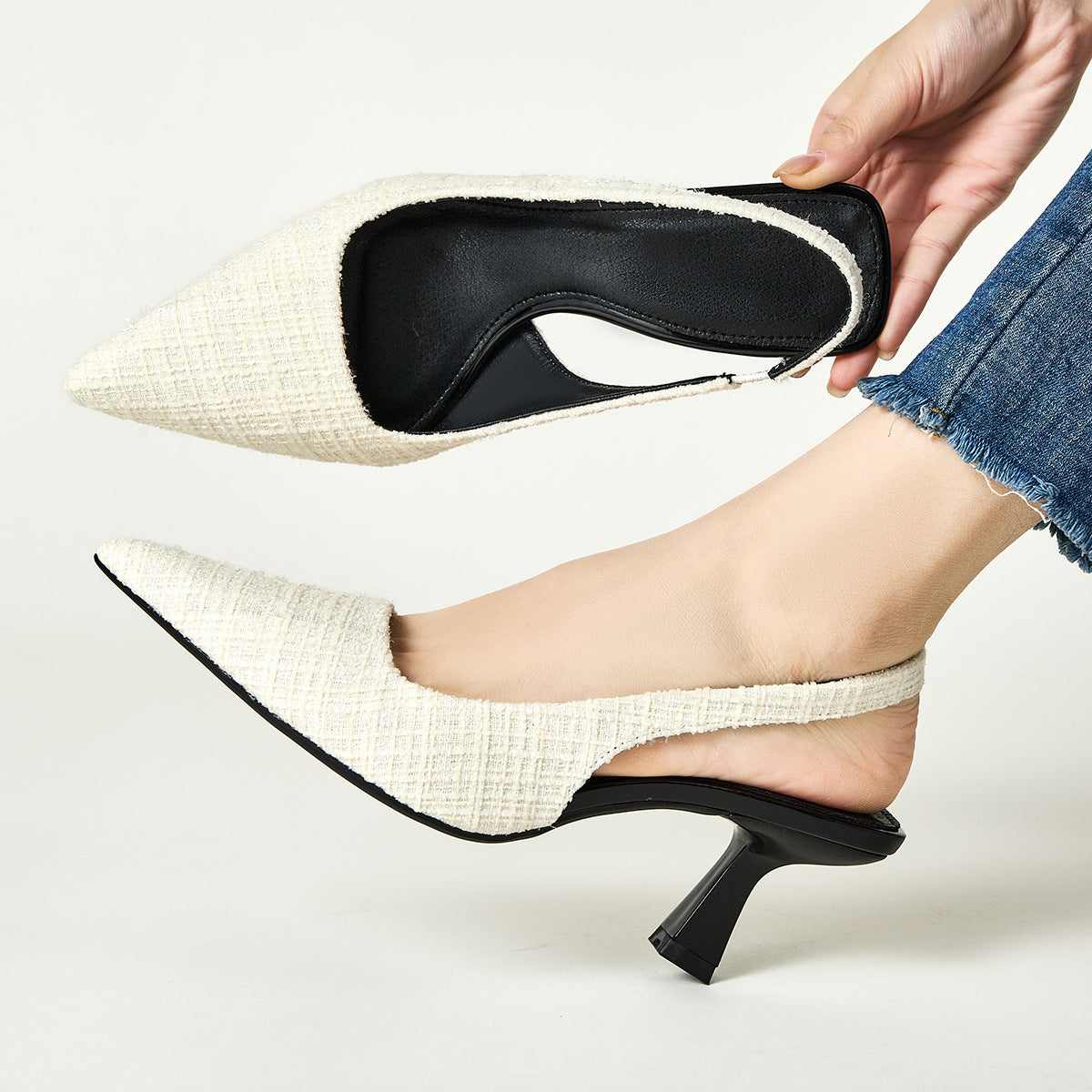 White tweed slingback pumps with pointed toe and flared heel, black interior