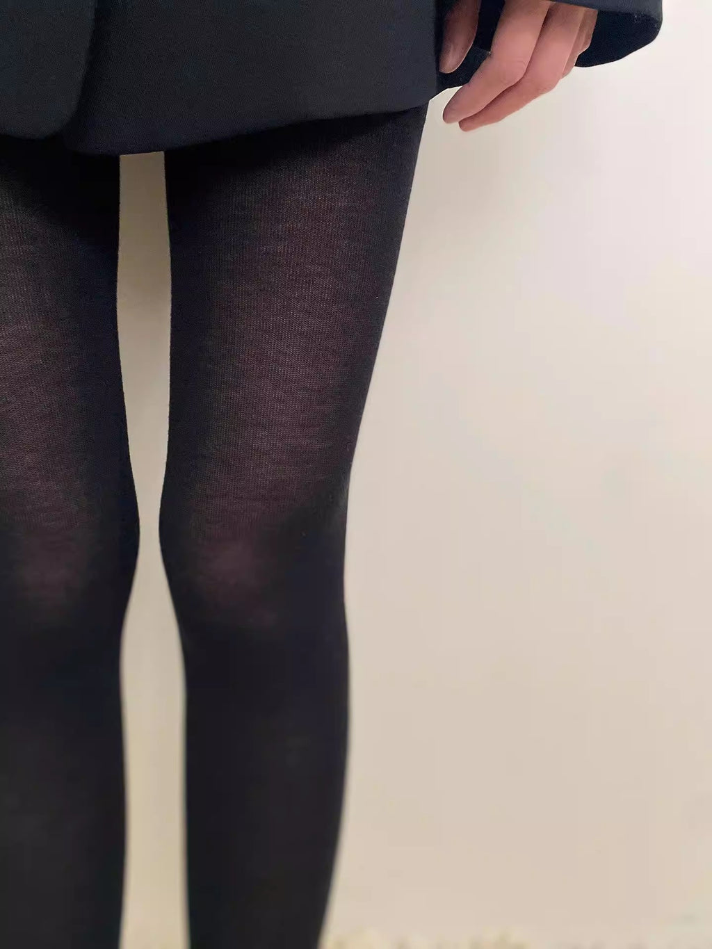 Black semi-sheer tights close-up showing the heathered knit