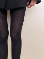 Black semi-sheer tights close-up showing the heathered knit