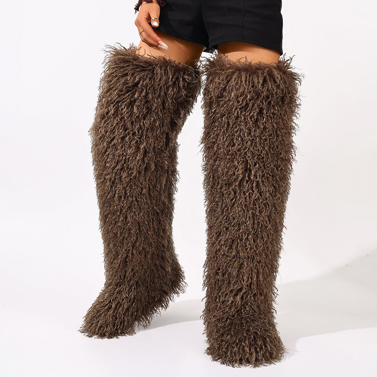 Dark brown shaggy thigh-high boots with a thick fur texture