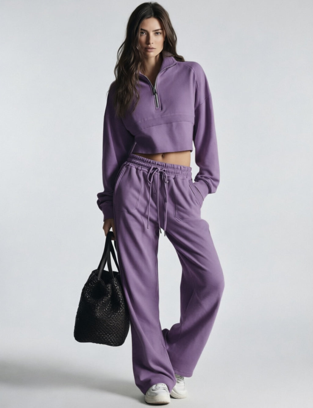 Purple women's sweatsuit with cropped half-zip sweatshirt and wide-leg drawstring pants