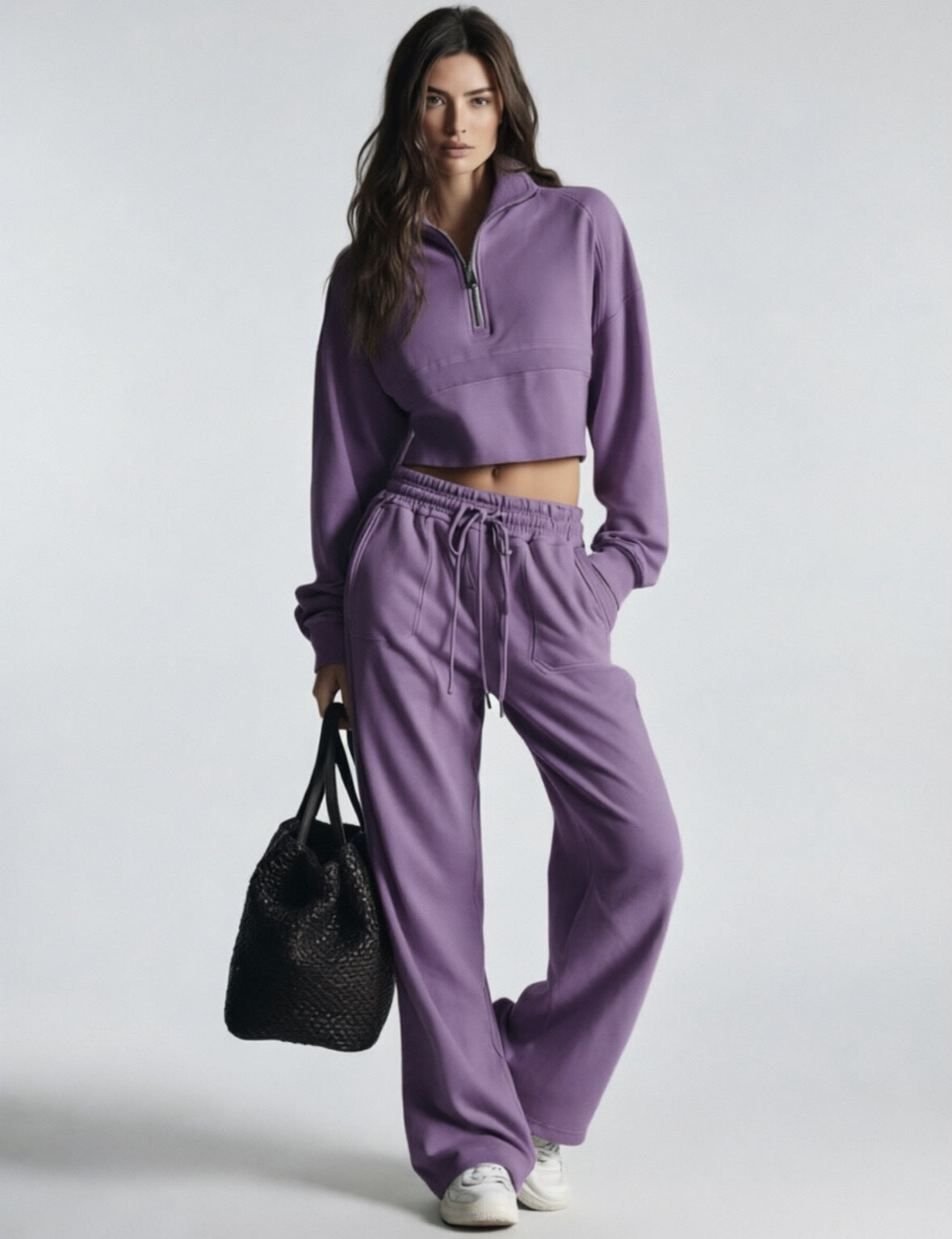 Purple women's sweatsuit with cropped half-zip sweatshirt and wide-leg drawstring pants