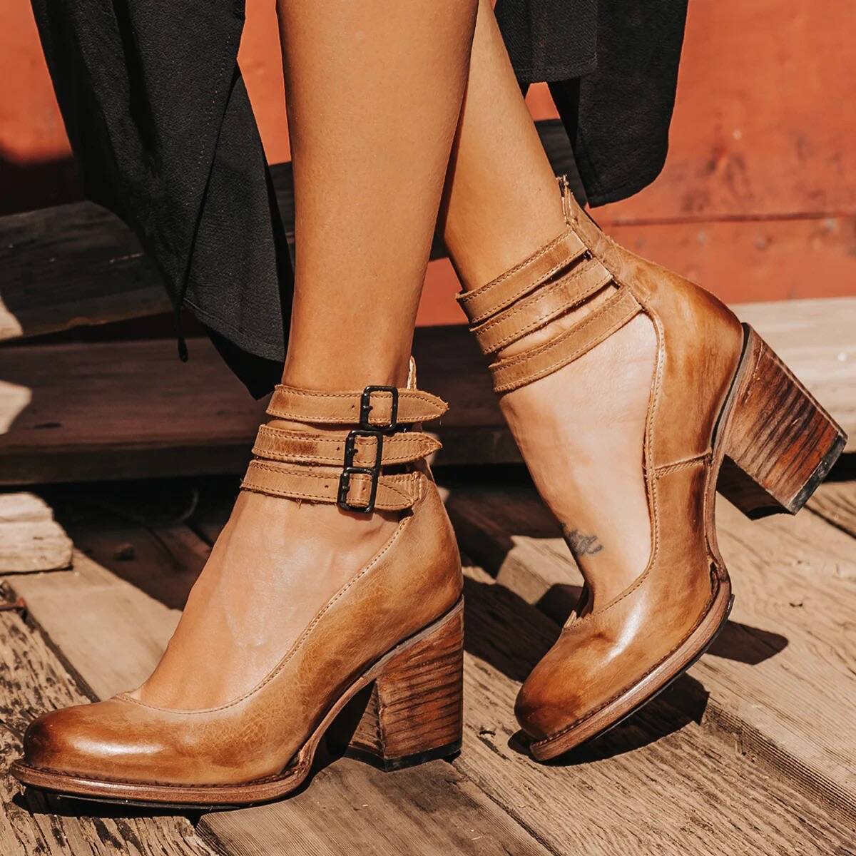 Tan closed-toe block heel pumps with ankle strap and square buckle