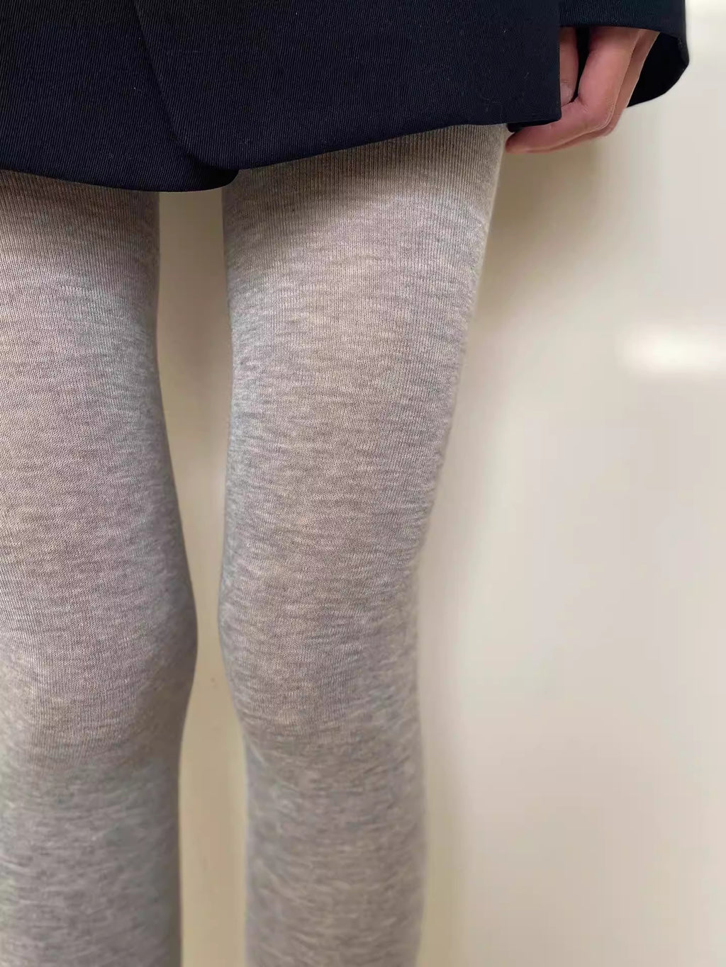 Light gray heathered tights close-up showing the knit texture