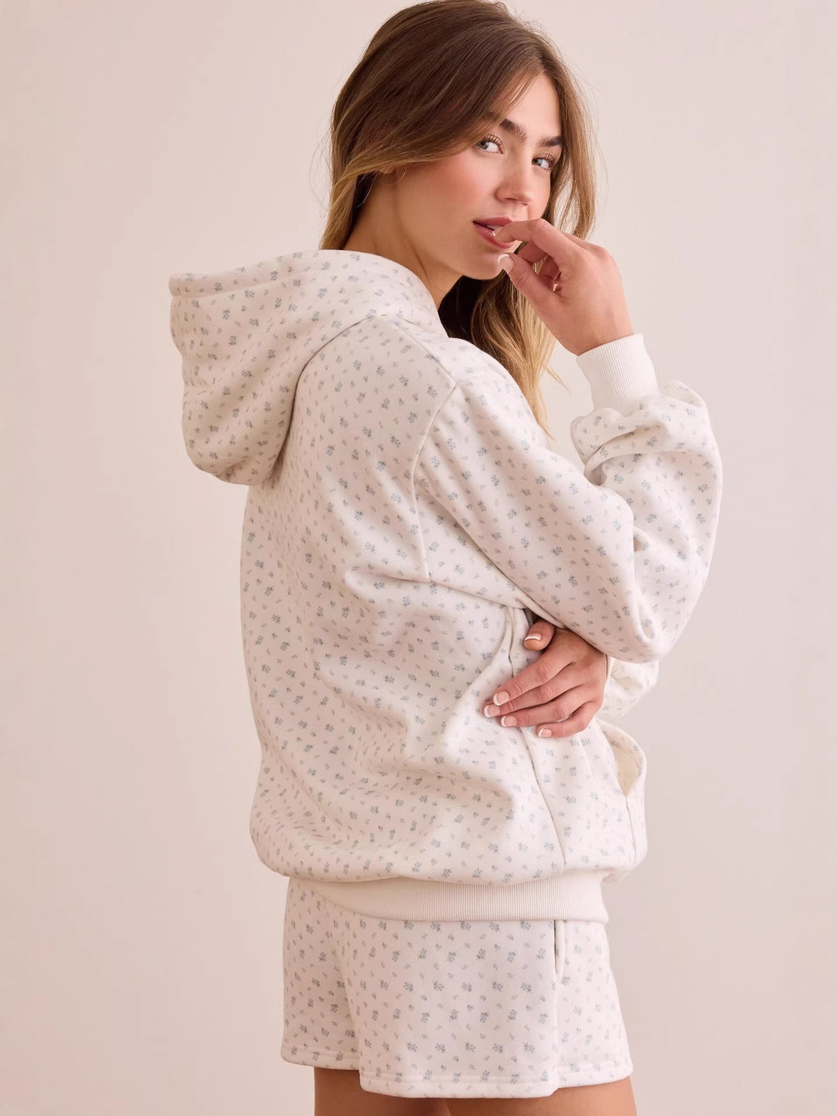 Back/side view of white ditsy floral oversized hoodie with kangaroo pocket