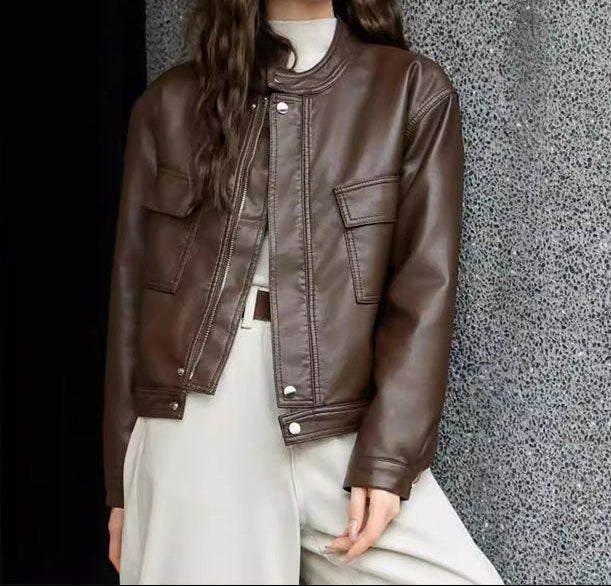 Brown cropped faux leather jacket with band collar, snap placket, and flap pockets