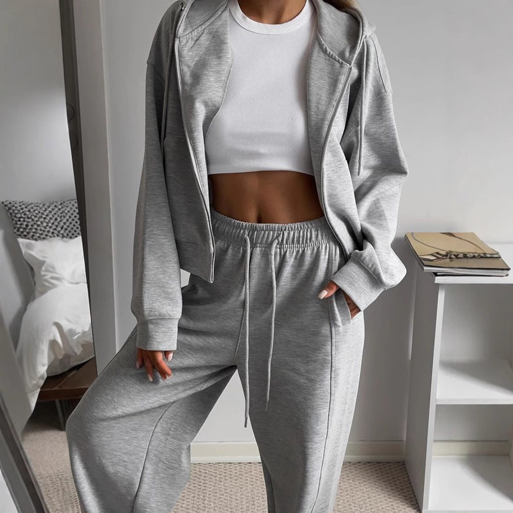 Women’s heather gray zip-up hoodie and drawstring sweatpants set, soft fleece.