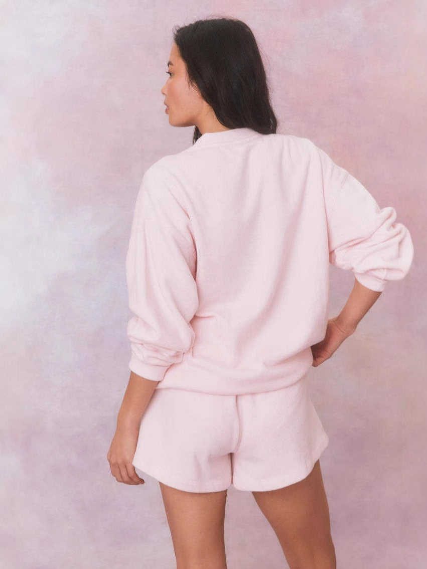 Light pink crewneck sweatshirt with relaxed fit, back view