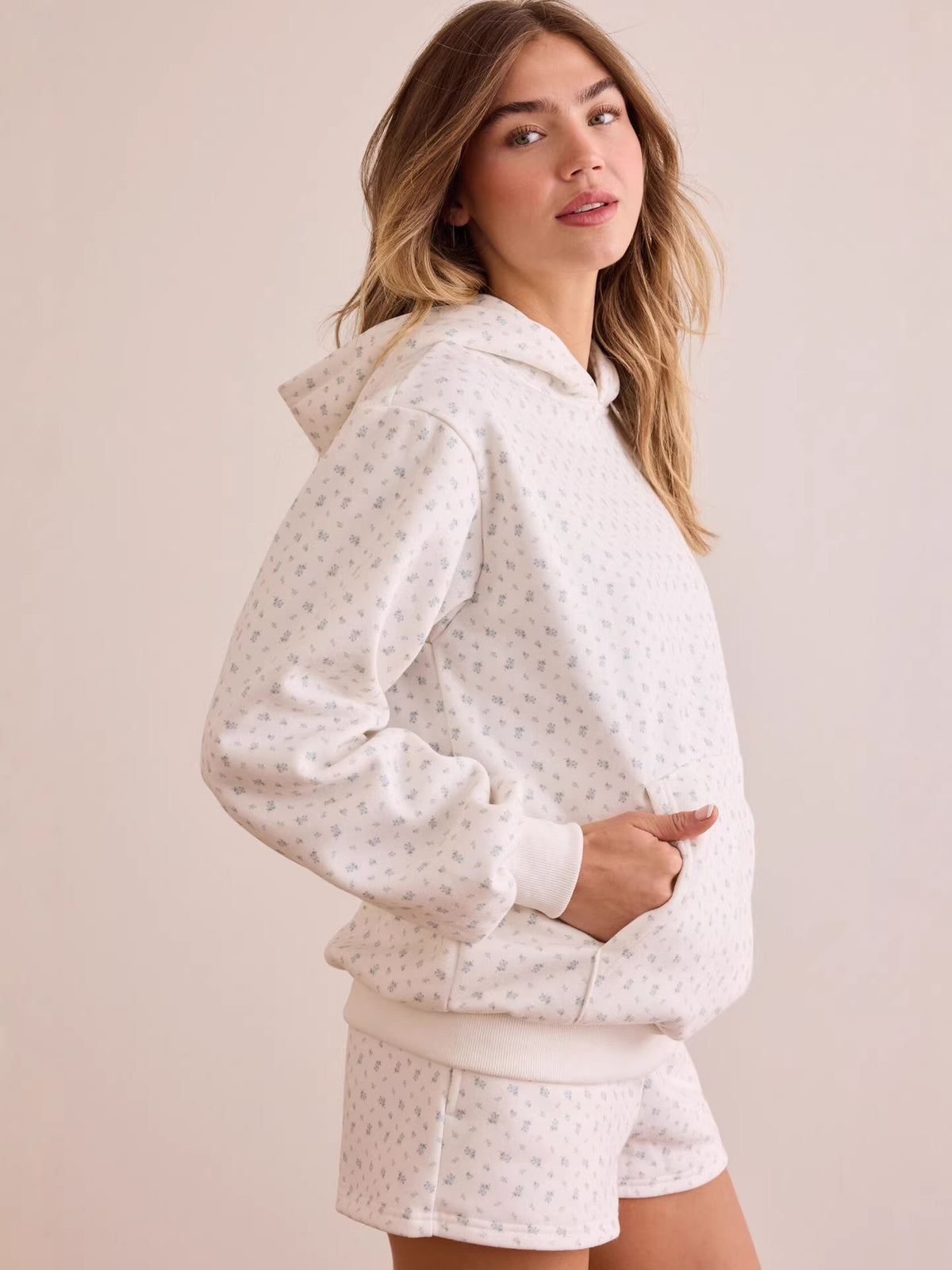 Side view of white ditsy floral oversized hoodie with kangaroo pocket