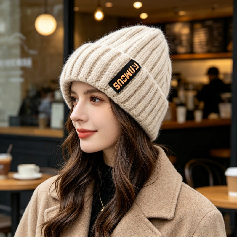 Chunky ribbed knit beanie hat in white with folded cuff and front letter patch