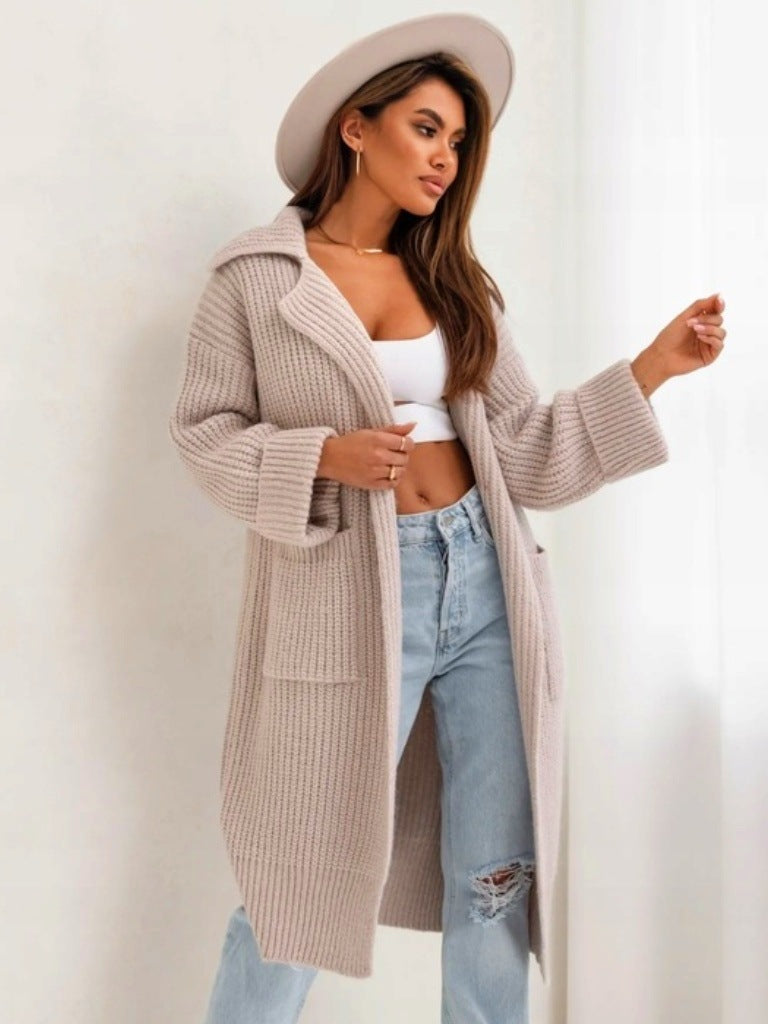 Beige long duster cardigan with notched collar, chunky ribbed knit, side pockets