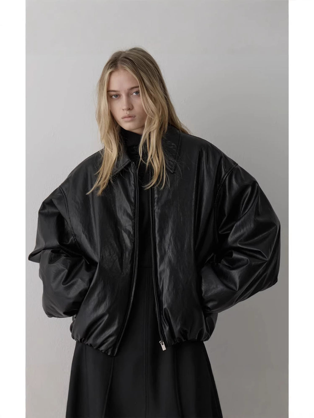 Black padded bomber jacket with point collar, balloon sleeves, and zip front detail