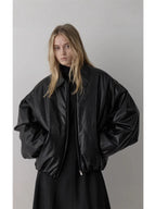 Black padded bomber jacket with point collar, balloon sleeves, and zip front detail
