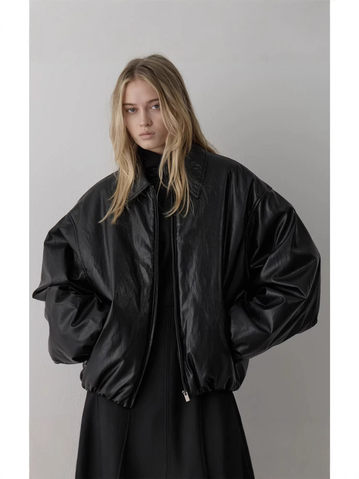 Black padded bomber jacket with point collar, balloon sleeves, and zip front detail