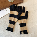 Women’s striped knit gloves in black and tan with long ribbed cuffs and five-finger design