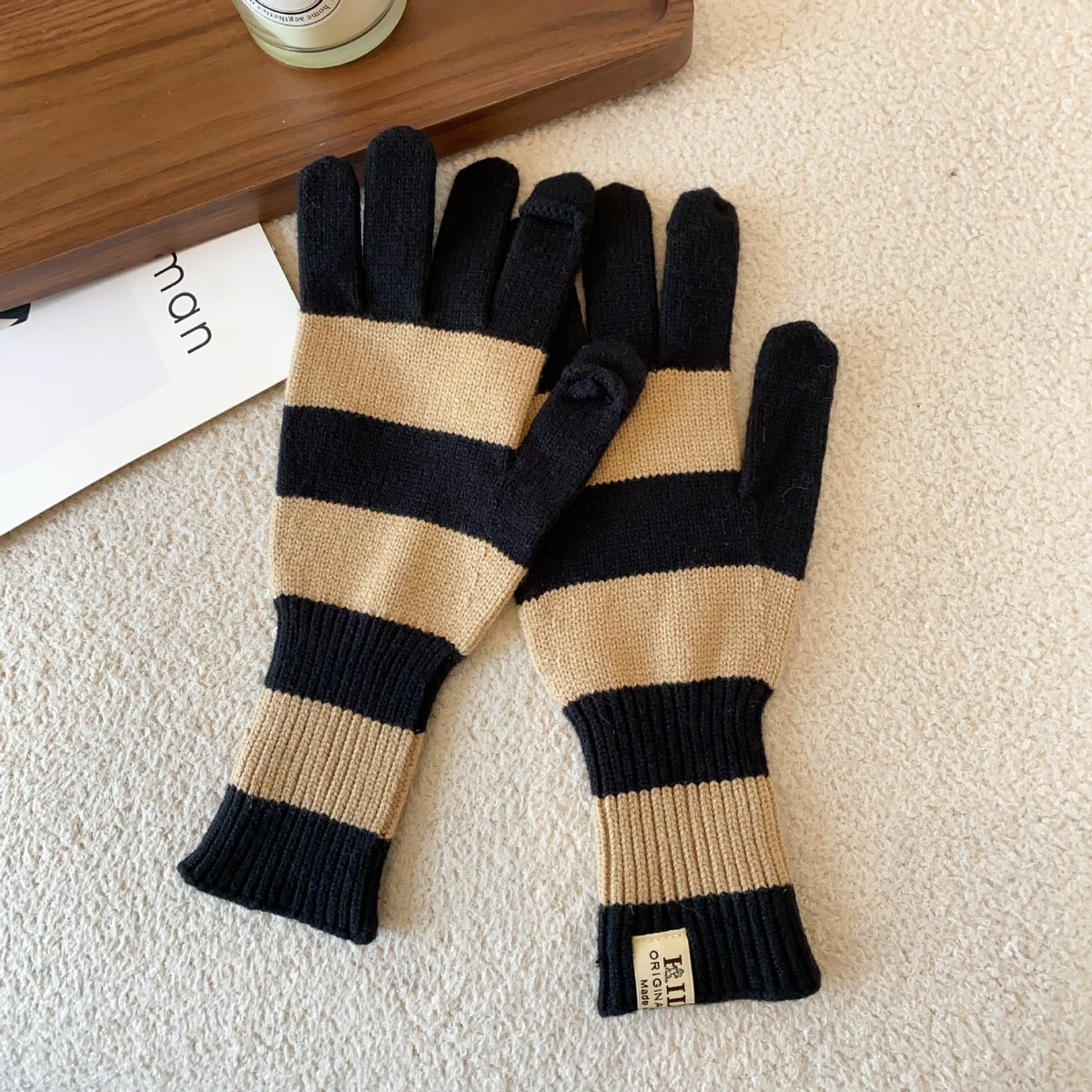 Women’s striped knit gloves in black and tan with long ribbed cuffs and five-finger design