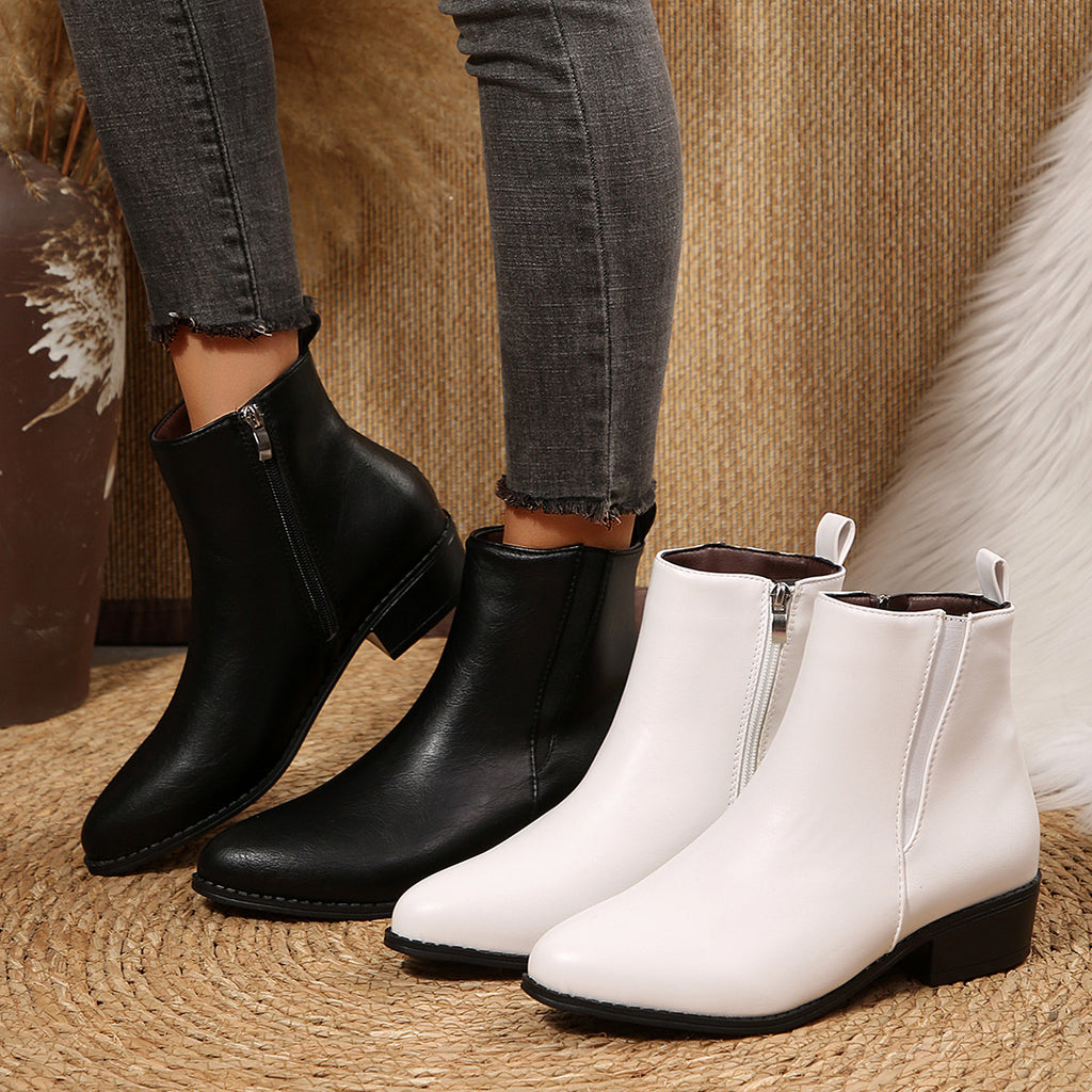 Pointed-toe ankle booties in black and white faux leather with side zip and low heel