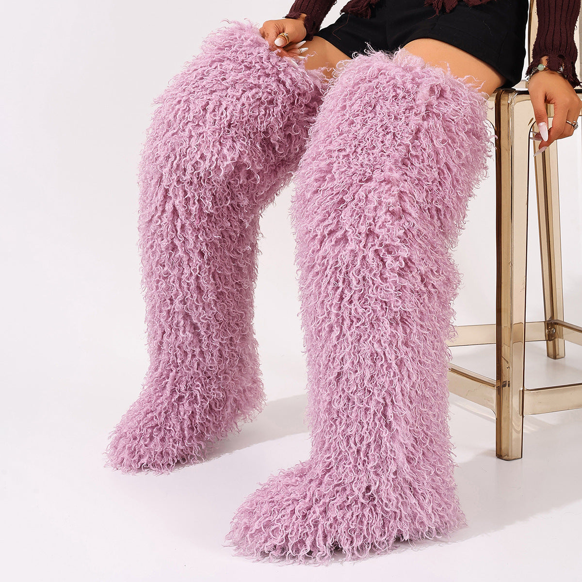 Pink faux fur thigh-high boots with dense curls and rounded toes