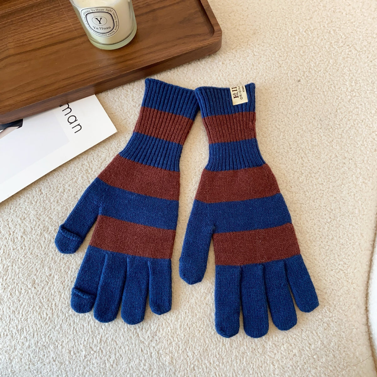 Women’s striped knit gloves in blue and brown with long ribbed cuffs and five-finger design