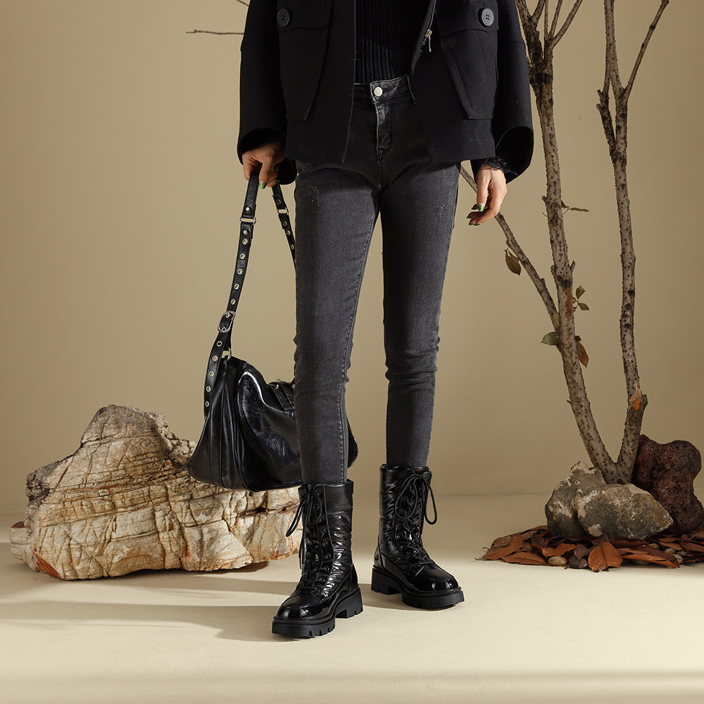 Black lace-up combat boots with chunky lug soles, calf-high