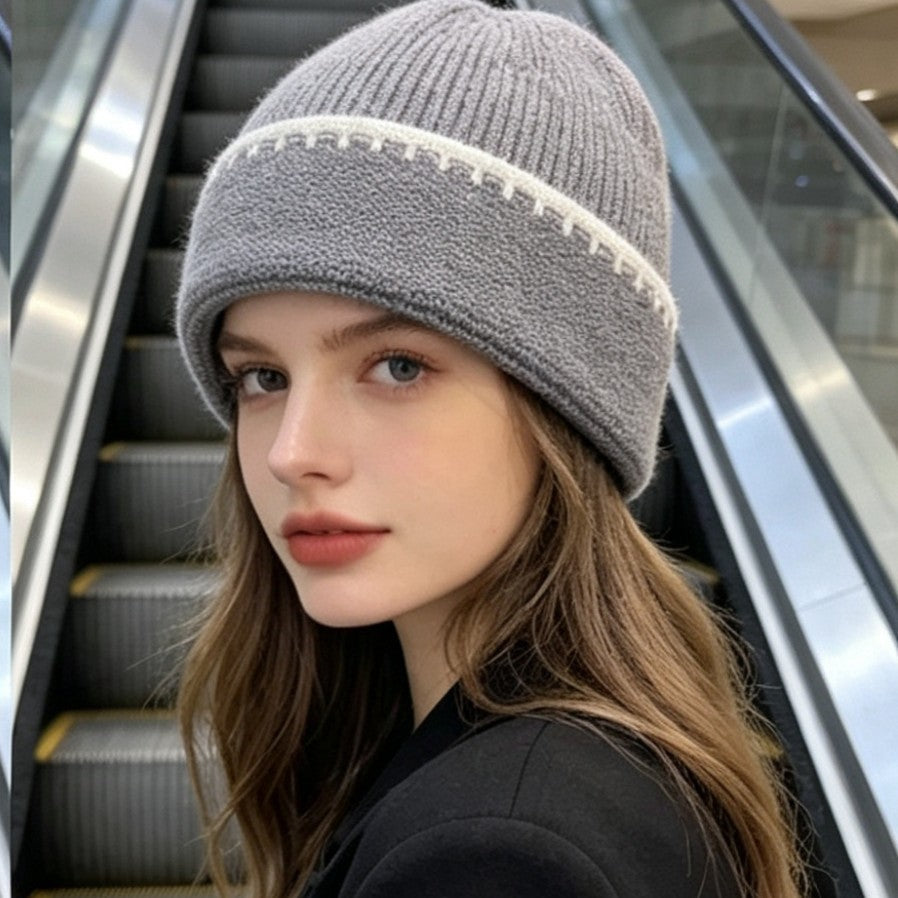 Ribbed knit beanie in gray with white contrast stitch stripe at the cuff.