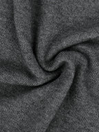 Gray knit fabric close-up with soft texture and subtle heather pattern
