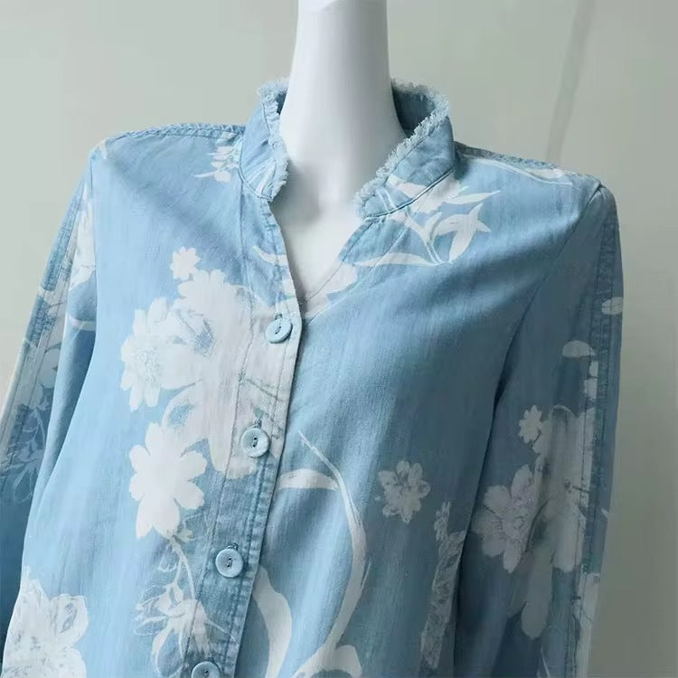 Close-up of blue sheer floral blouse: ruffle collar and button front with long sleeves