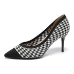 Women’s black and white houndstooth knit stiletto pumps with pointed toe.