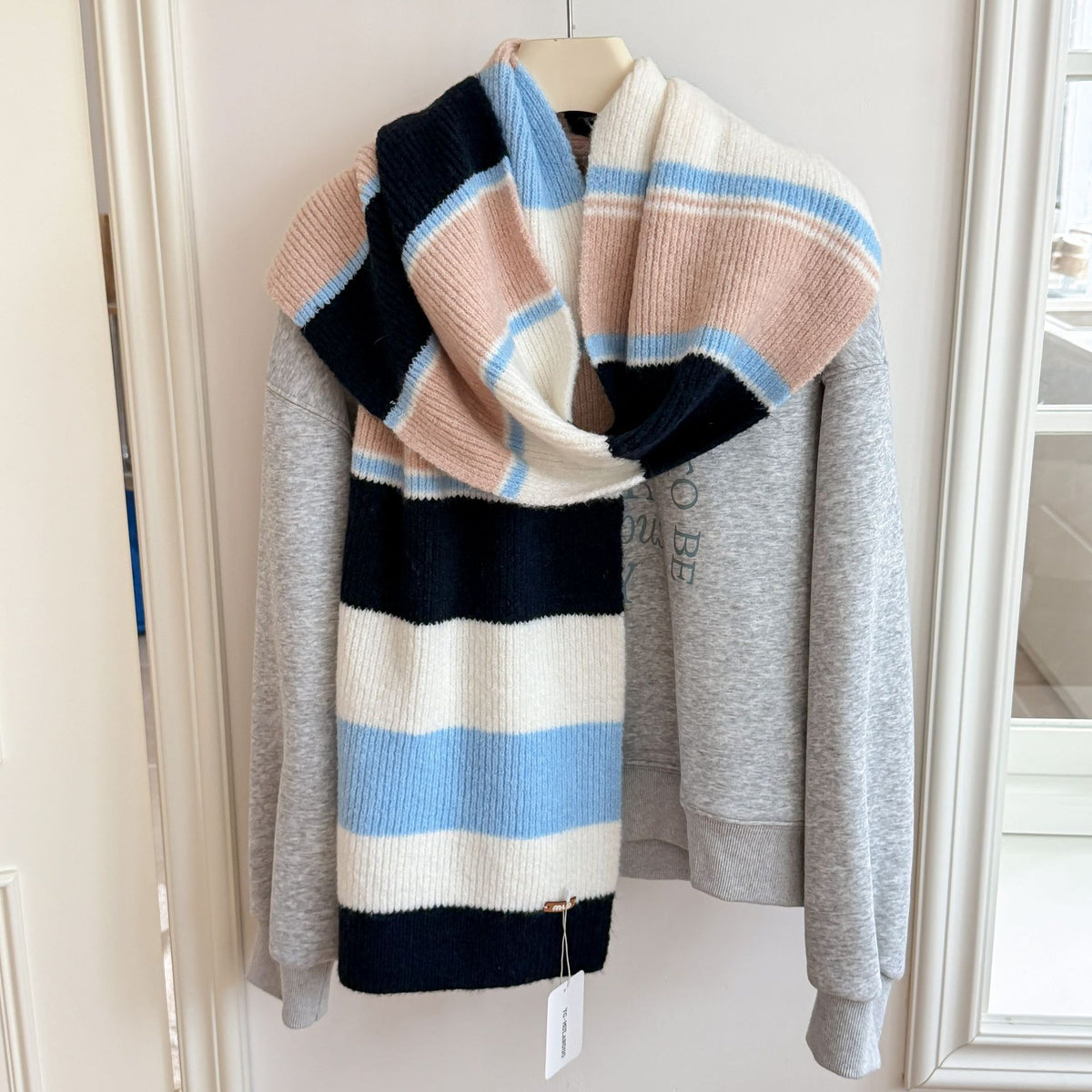 Women’s long striped wool scarf with wide knit stripes in navy, cream, and pale blue.