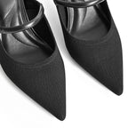 Close-up of black knit pointed-toe mule with buckle strap and stiletto heel