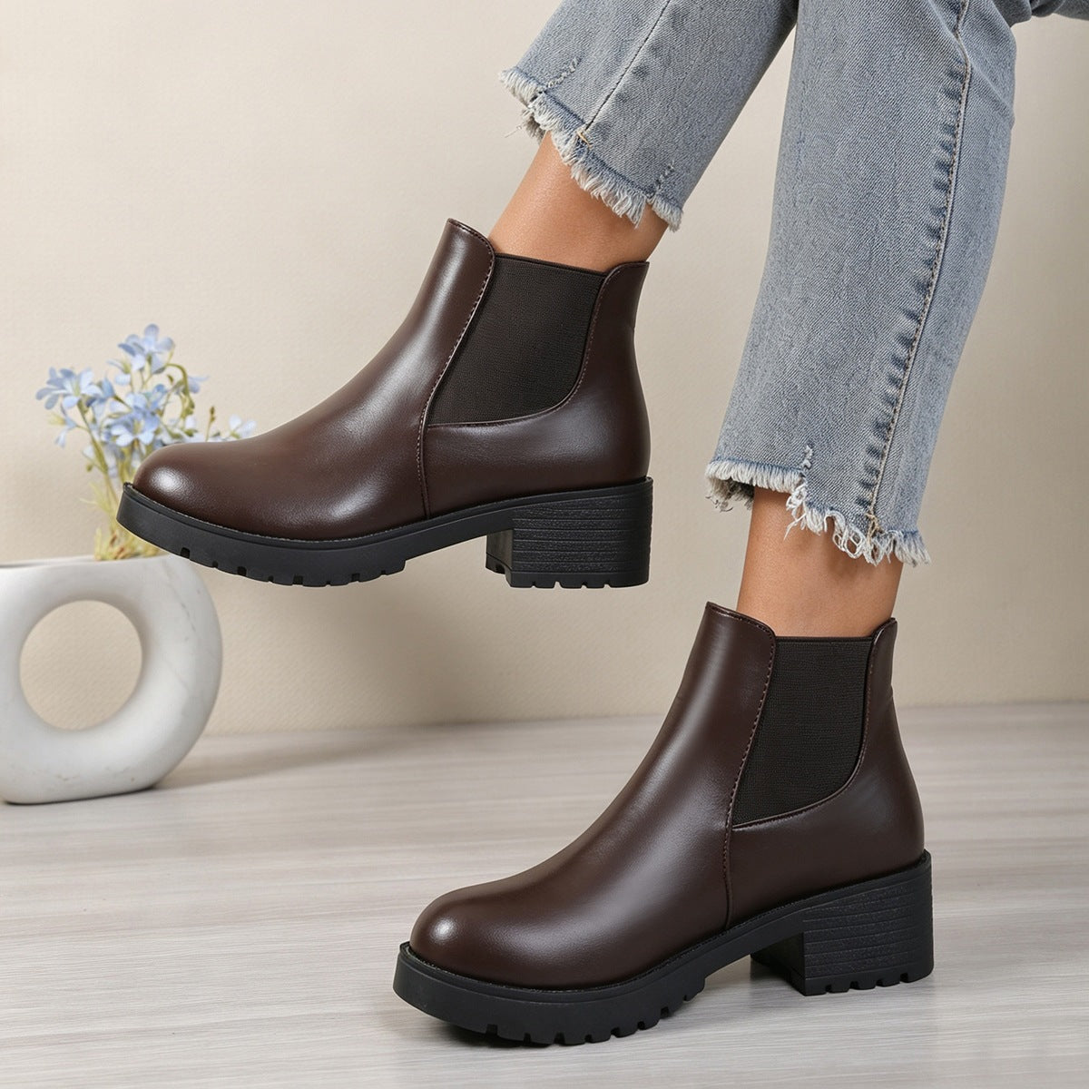 Women’s chunky Chelsea boots in dark brown with elastic sides and lug sole, mid block heel.