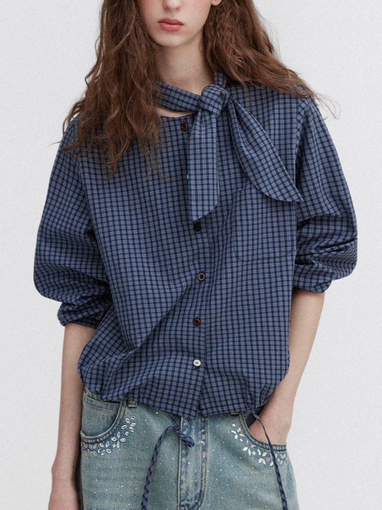 Dark blue plaid tie-neck blouse with button front and gathered puff sleeves