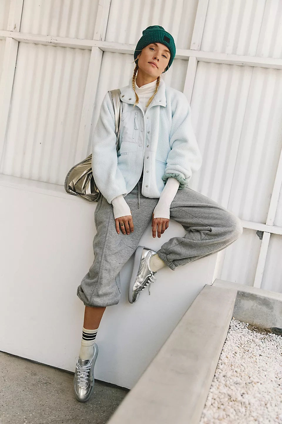 Women’s sherpa jacket in light blue with snap front and stand collar; zip pockets