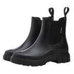 Chelsea rain boots in black matte rubber with elastic pull-on panels and lug sole.