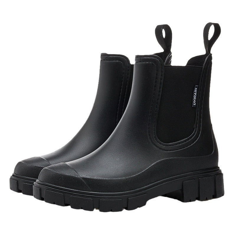 Chelsea rain boots in black matte rubber with elastic pull-on panels and lug sole.