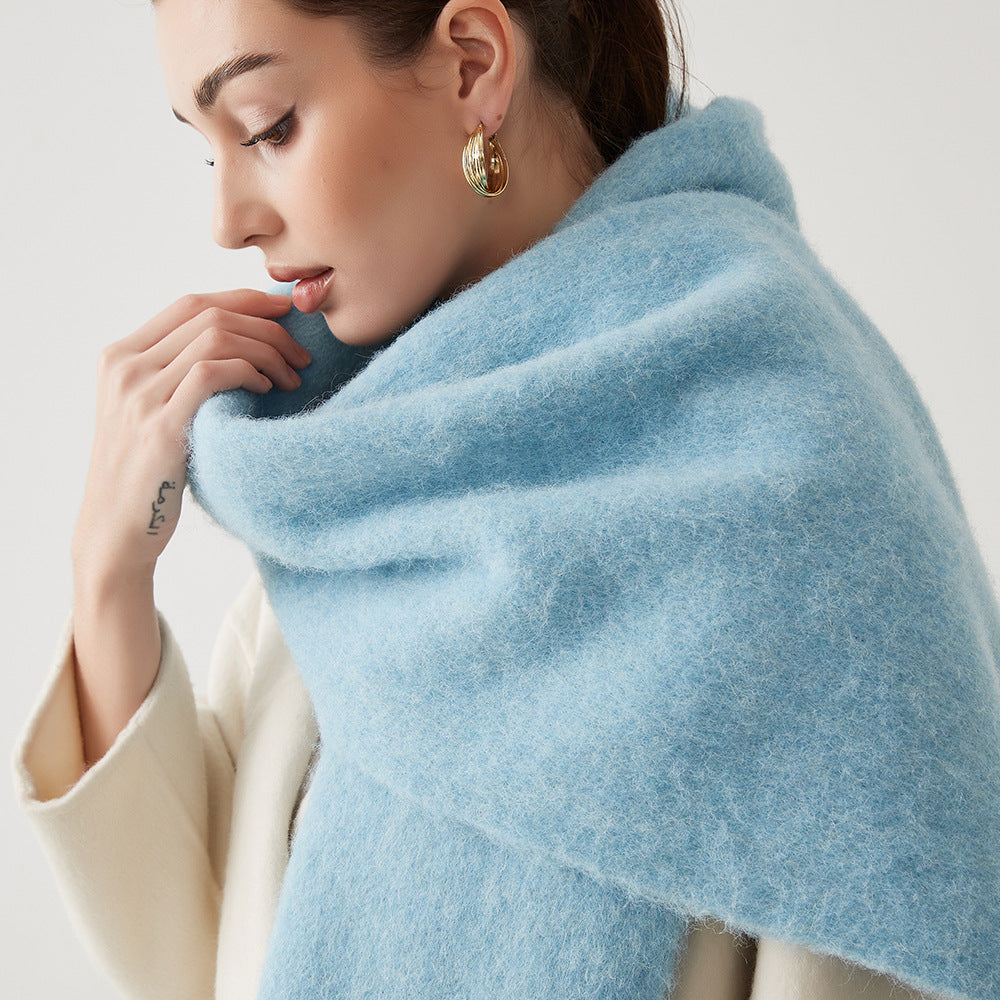 Oversized fuzzy mohair-blend scarf with fringe ends, light blue, worn draped over shoulders