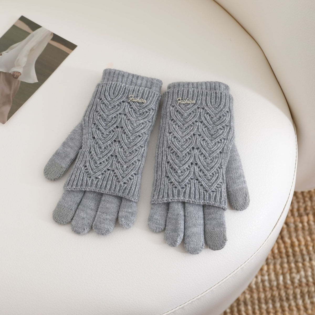 Women’s gray fingerless knit gloves with ribbed cuffs and textured wave pattern