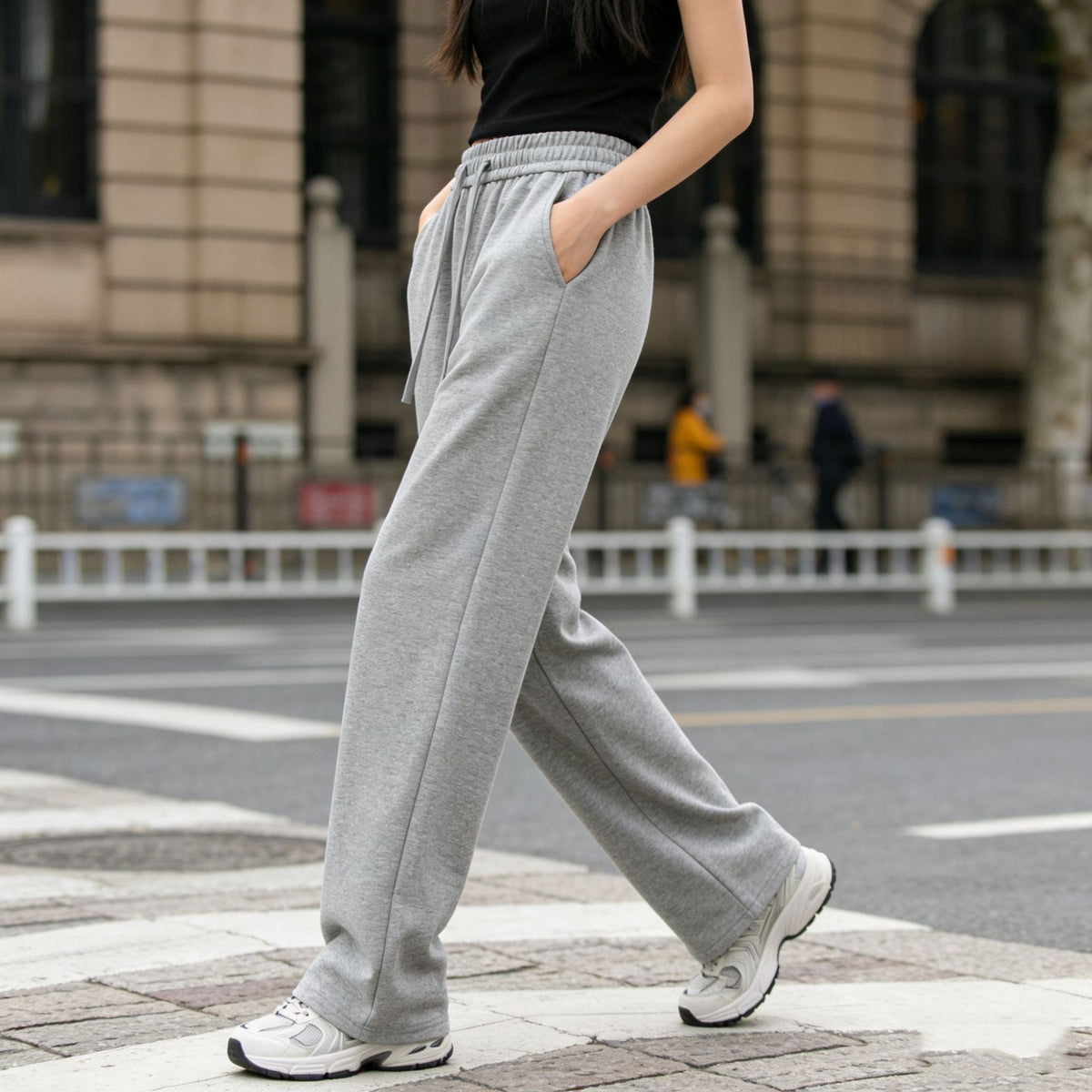 Women’s light gray wide-leg sweatpants with drawstring waistband and side pockets