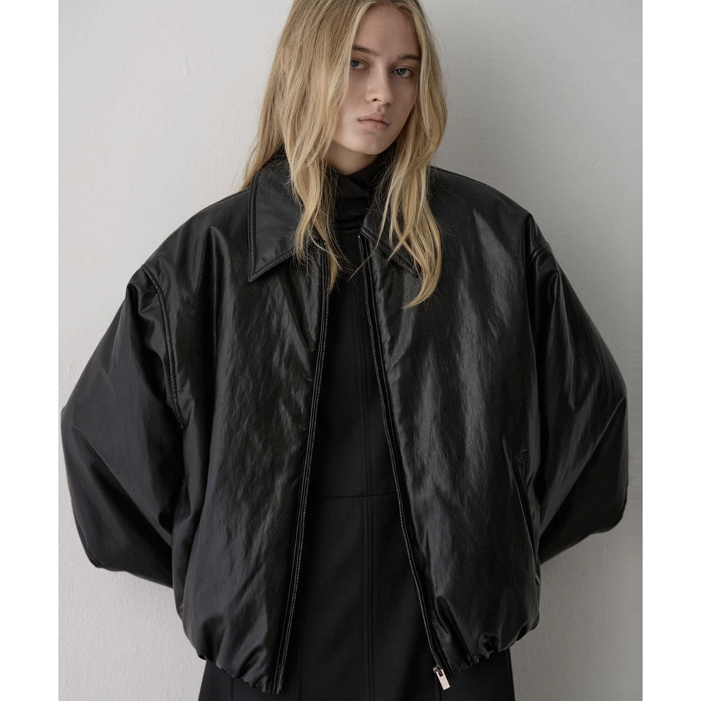 Black faux leather bomber jacket close-up: point collar and zip front