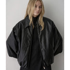 Black faux leather bomber jacket close-up: point collar and zip front