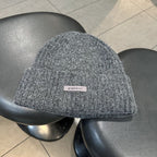 Dark gray fuzzy knit beanie with woven "pipiswoot" label